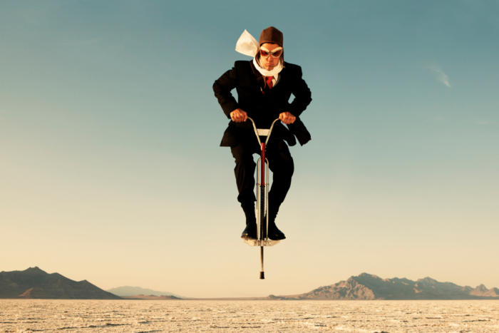 man jumps on a pogo stick